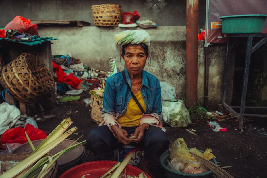 Traveler cheerfully interacts with a vendor while buying fresh produce at a sunny outdoor local market, embodying communit...