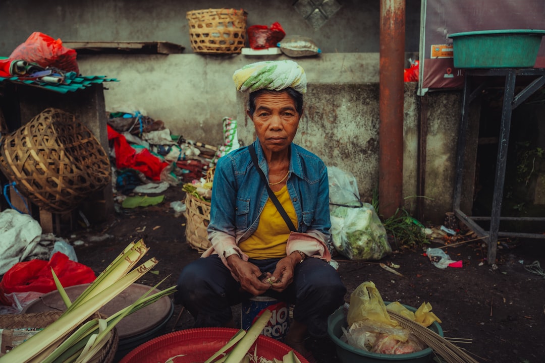 Traveler cheerfully interacts with a vendor while buying fresh produce at a sunny outdoor local market, embodying communit...