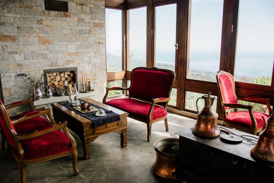The warm, inviting interior of a hidden, traditional Lake District pub with a roaring fireplace, showcasing the type of authentic experience tourists are searching for.